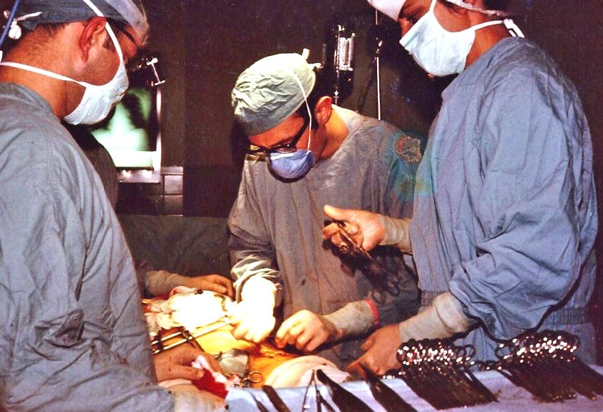 Three surgeons performing surgery