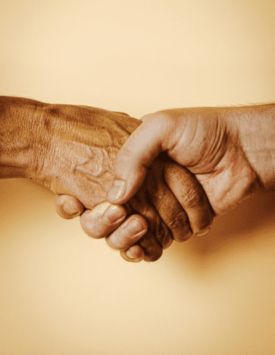 A handshake on a calm yellow background