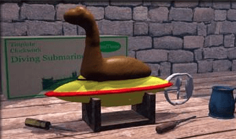 Brown putty "monster" shape on top of yellow and red toy submarine on worktable